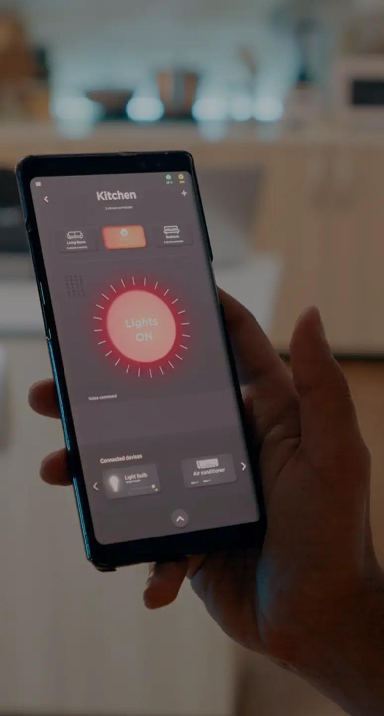 Hand holding a phone running a smart home climate app